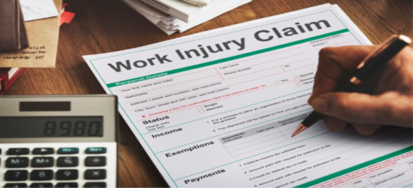 a person filling workplace injury claim form