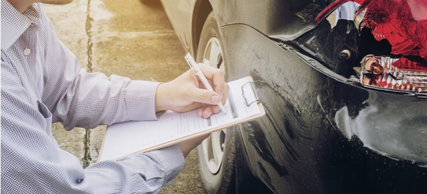 a person checking the vehicle damage after Texas car accident